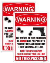 Ovyxely No Trespassing sign with armed warning, deterring intruders at night.