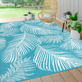 Pauwer leaf teal reversible outdoor rug displayed on patio for versatile decor.
