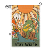Perfectinsoy Stay Weird flag with snail and frog design adds whimsy to garden.