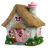 PRETMANNS fairy house outdoor pink adds whimsy as a charming garden centerpiece.