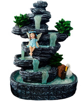 QCF Fairy Garden Waterfall statue glowing in evening outdoor scene