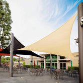 Royal Shade beige triangle shade sail provides patio sun protection.