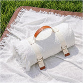 RYCHIC 2-in-1 extra-large camping blanket folded for easy transport and quick setup.