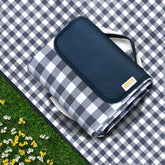 SAMSIER navy outdoor picnic blanket spread on grass for a family picnic.