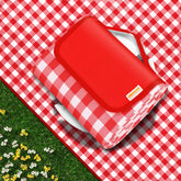 SAMSIER picnic blanket laid flat on grass; waterproof and sandproof for family picnics.