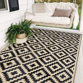 Sand MINE waterproof outdoor rug in black and beige for patios and decks, weather resistant.