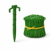Smart Spring 4in biodegradable stakes in soil provide sturdy, eco-friendly support for landscape projects.