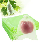SmileLucky fruit protection bag with drawstring shielding berries on a branch