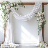 Socomi white sheer arch drape hangs softly for wedding ceremony backdrop