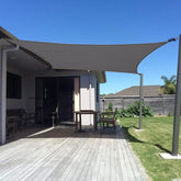 Sunny Guard sun shade sail in dark grey over backyard providing cooling shade.