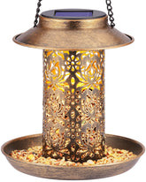 Sweetfull solar bird feeder lantern hanging in garden attracts cardinals at dusk.