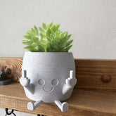 sxidpda smiling plant pot with middle fingers up adds playful indoor decor.