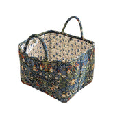 Sylet quilted basket with a front pocket for quick home organization.