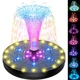 SZMP solar fountain with 60 LED lights illuminating a night garden.