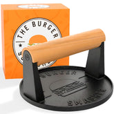 The Burger Smasher cast iron smash press on a hot griddle for crisp patties