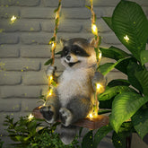 Thyle solar raccoon on swing lights up outdoor spaces at night