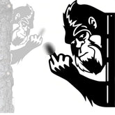 Tiinasol peaking Boo Bigfoot metal sign features animals peeking around a corner, outdoor whimsy.