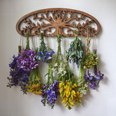 Tnstbiee Tree of Life drying rack mounted on wall for herb drying.