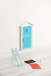 Tonttuovi fairy door on the wall with open panel for imaginative play and note exchanges.