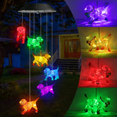 Toodour solar wind chime with six dog lights lighting up the garden at night