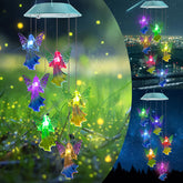 Toodour solar wind chimes with angel lights illuminating a garden at night