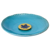 Topadorn birdbath with blue glaze inviting birds to sip and bathe