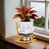 Toparad Smiley Face Rocking Chair Planter on a shelf with small succulents.