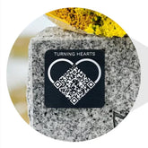 Turning Hearts QR medallion on a headstone linking to a personalized memorial page.