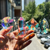 TXXNSM crystal sun catcher prism on a window casts vivid rainbows.