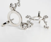 vskikris silver-plated crystal ball stand for small spheres on a desk.