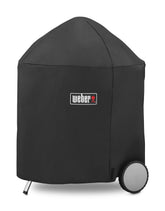 Weber 26-inch charcoal grill cover on the grill protecting from sun and rain