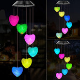 Wenana solar wind chimes illuminate outdoor spaces with color-changing lights at night.