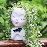 WEWEOW face planter full view showing a cute resin pot for plants.