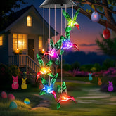 Winzwon solar hummingbird wind chime glows in garden at dusk for enchanting ambience.