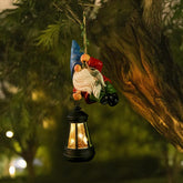 WONDHOME solar hanging gnome garden statue glowing softly in bright sun