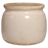 Xiaan Jiaju ceramic planter with antique ivory glaze on a living room shelf, ideal for indoor décor.