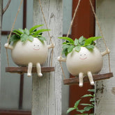 Xzunk swing planter face closeup highlighting resin detail for fun indoor decor.
