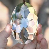 YU FENG crystal prism suncatcher window hanging creates rainbow light indoors.