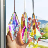 YU FENG crystal prism suncatcher on a window creates a vivid rainbow across the room
