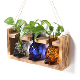 YYHglass skull propagation bottle on wooden stand for elegant tabletop display.