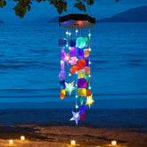 Zeiliuled Solar Shell Wind Chimes glow in garden at night for outdoor charm.