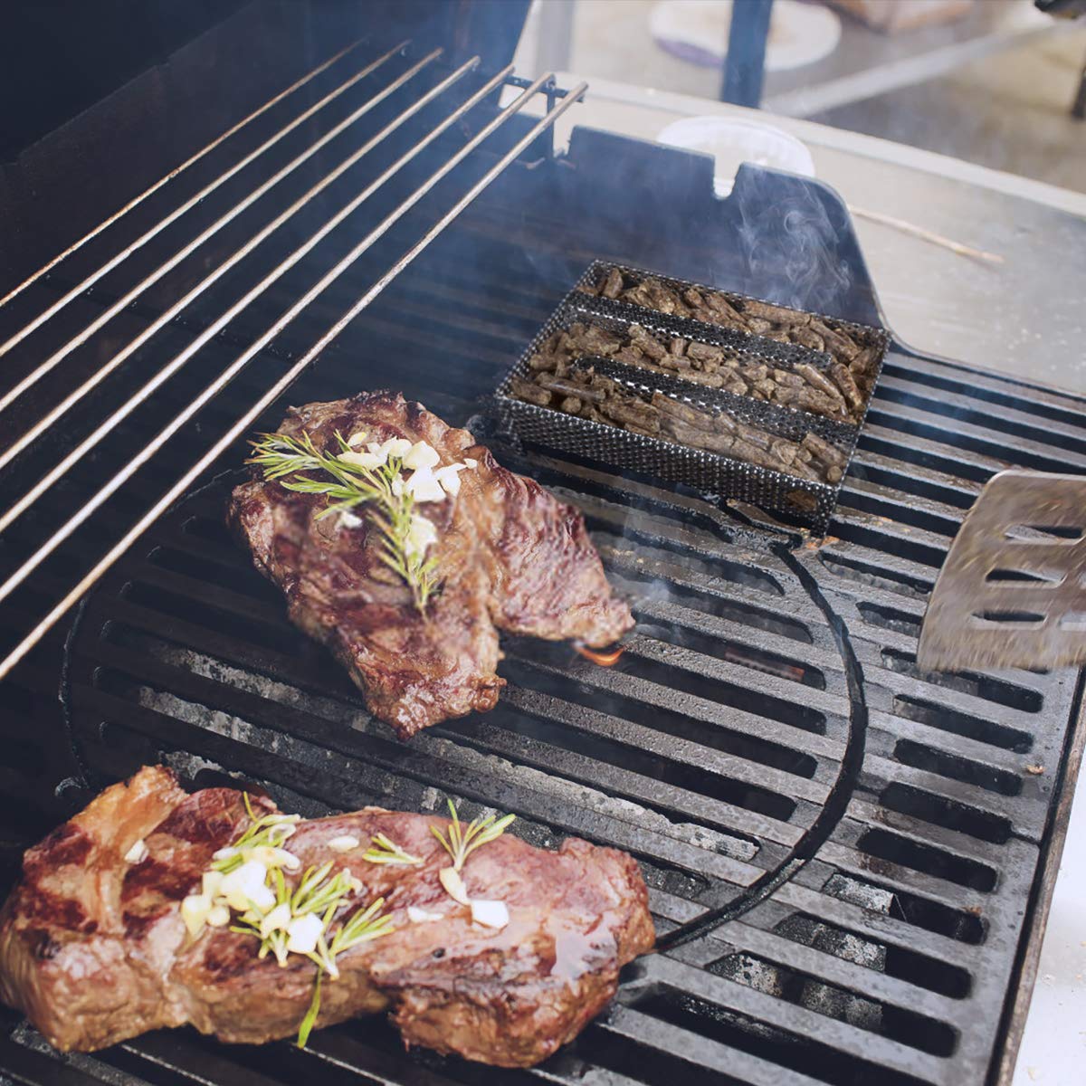 3 BUZZLETT smoker tray in action on a grill.