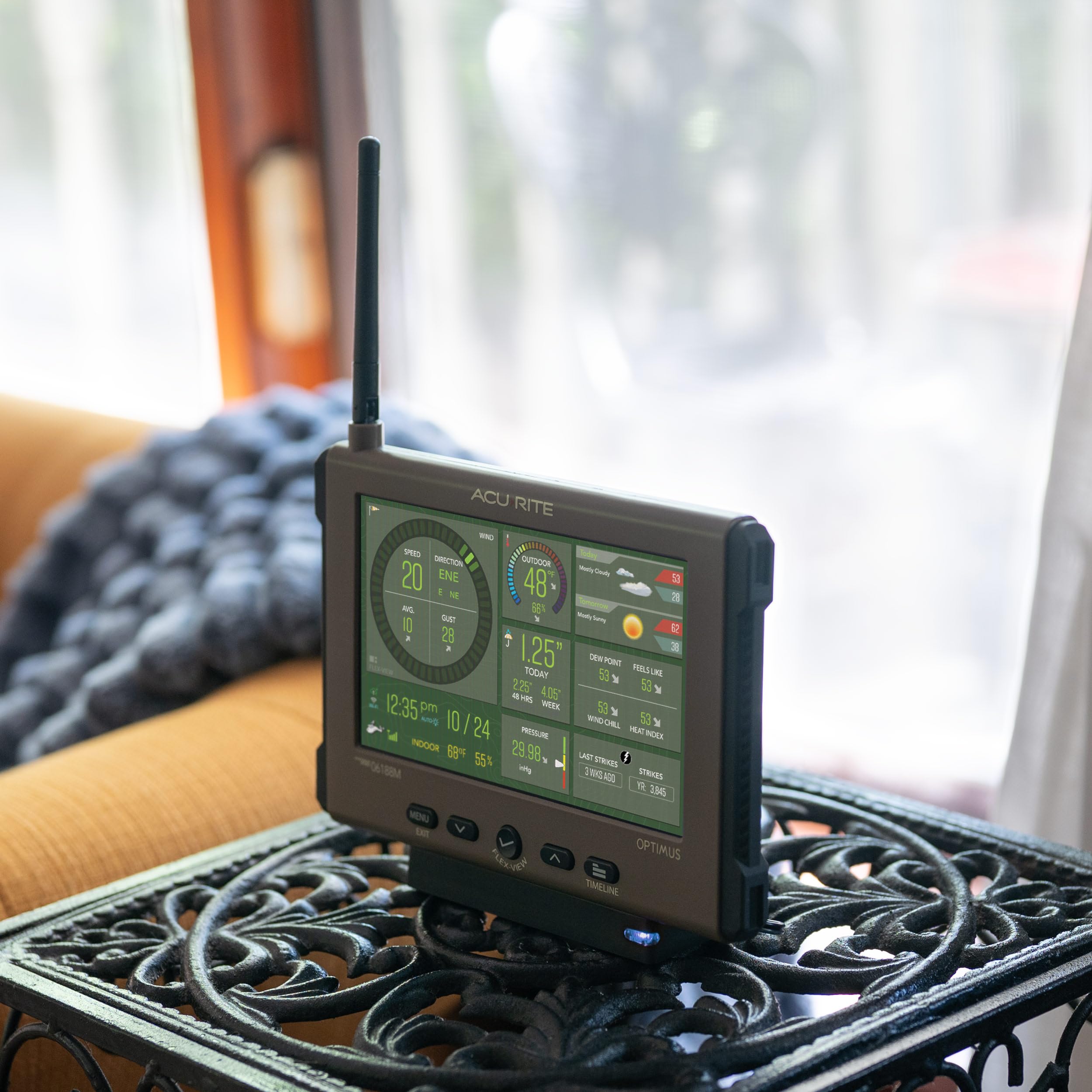 AcuRite Optimus outdoor sensor with a sleek low-profile design in a backyard.
