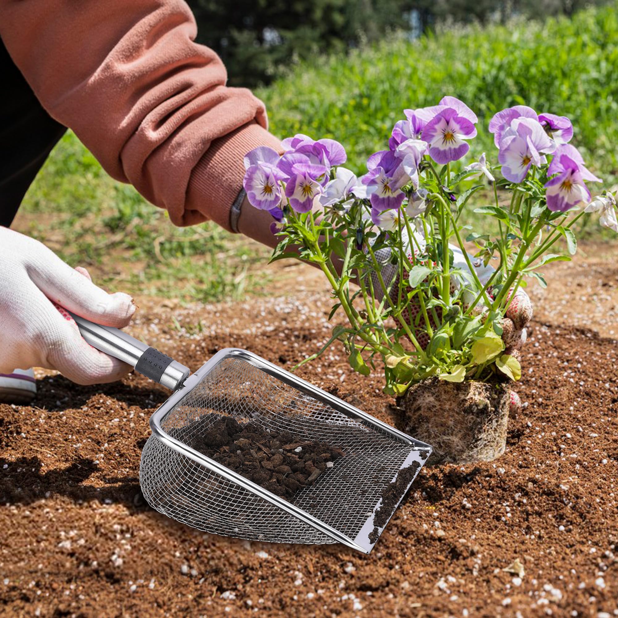 Adnee soil sifter with hanging loop for easy storage after use.