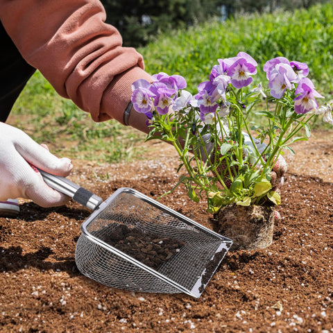 Adnee soil sifter with hanging loop for easy storage after use.