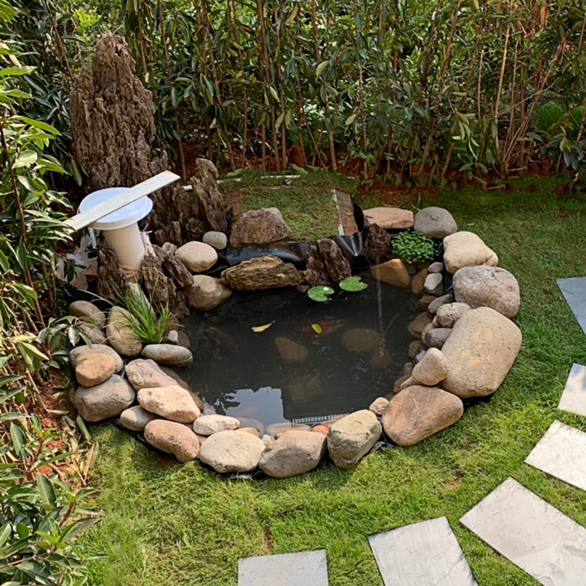 Adroiteet waterfall pond liner imagery emphasizing durable, sun-proof material in outdoor use.