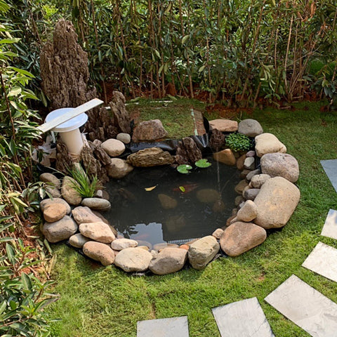Adroiteet waterfall pond liner imagery emphasizing durable, sun-proof material in outdoor use.