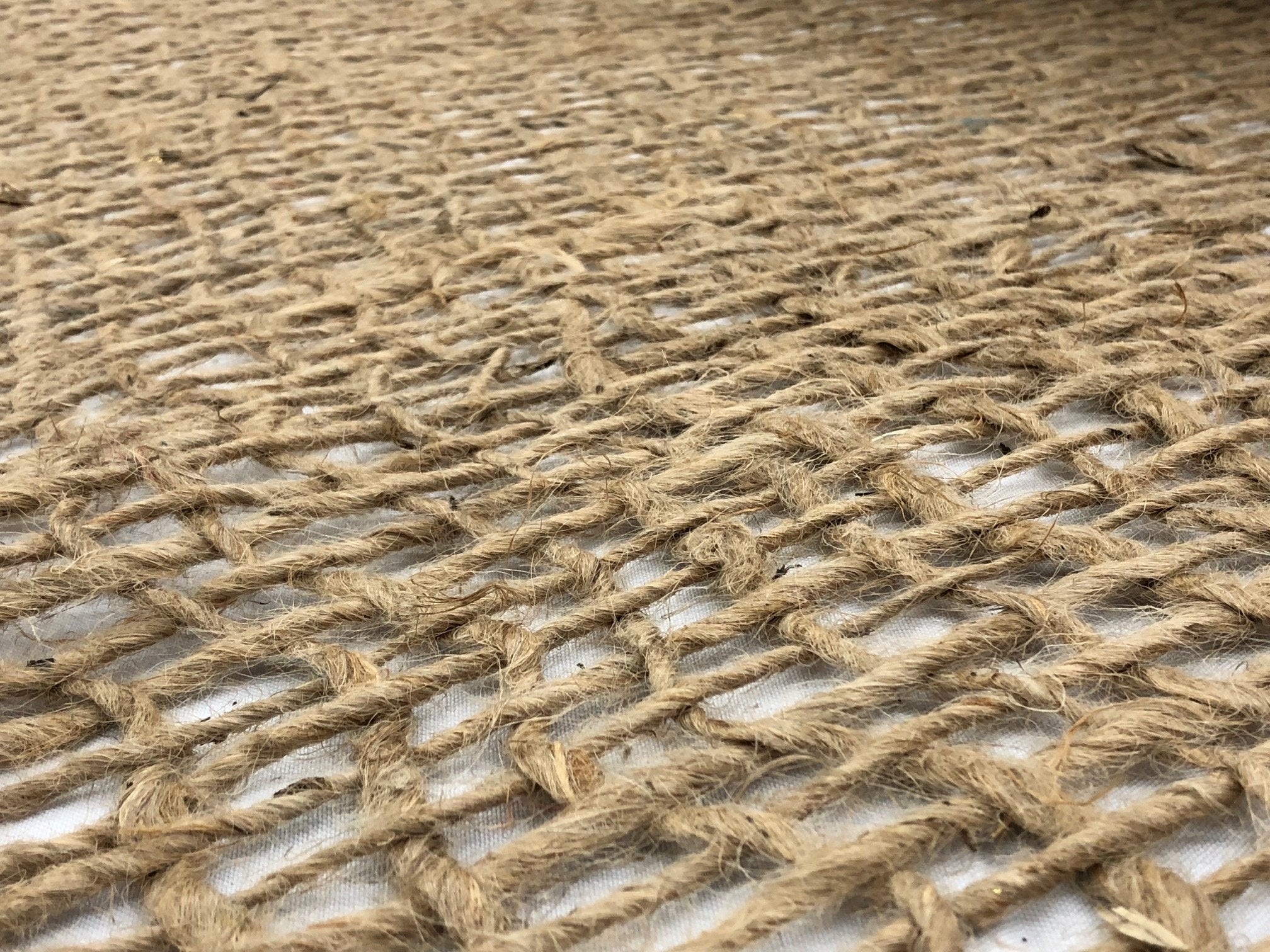 AK TRADING CO. Biodegradable jute mat blending with soil surface.