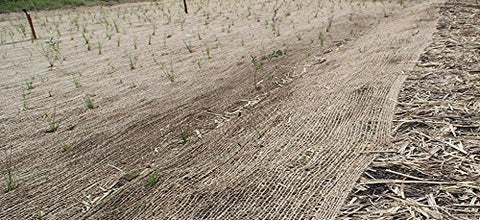 AK TRADING CO. Landscape protection using jute blanket over garden bed.
