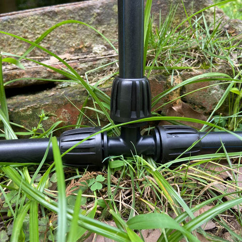 ALKARAMA anti-drop tee secures tubing under pressure in a garden setup